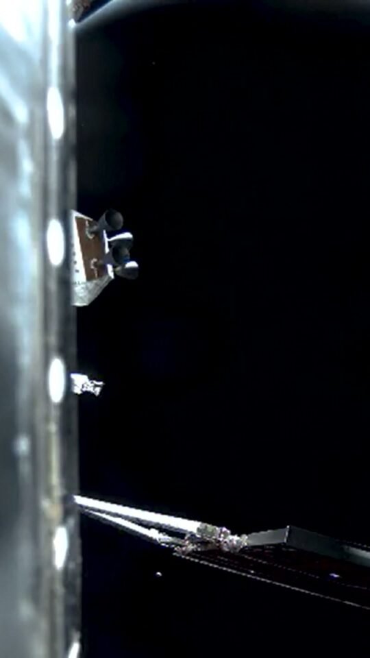 Crescent Earth beyond the Orion spacecraft in deep space